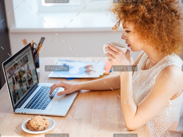 demo-attachment-1146-woman-photographer-drinking-coffee-and-working-PJNBP6U